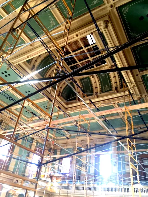 Decorative ceiling tiles are being restored with the use of scaffolding in the house chambers